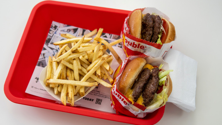 In-N-Out fries and two burgers on a red tray