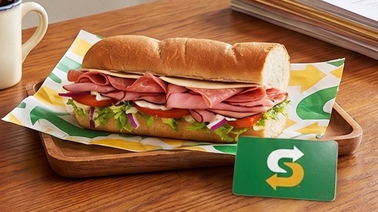 A sub from Subway sits on a desk