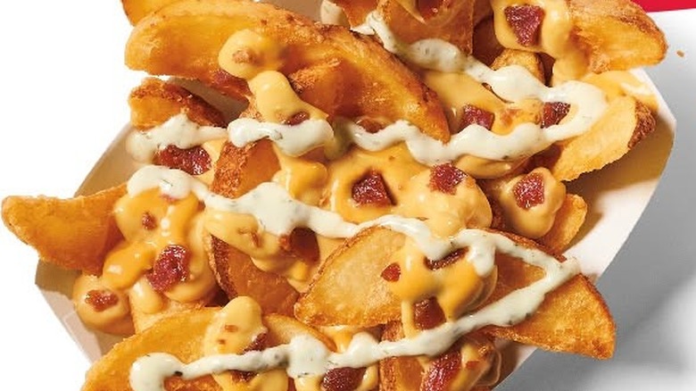 Served box of Jack in the Box loaded potato wedges.