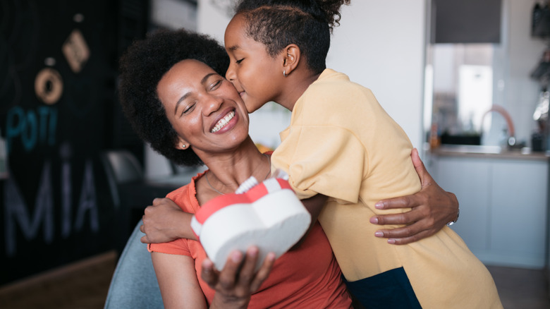 Child kissing mom on the cheek