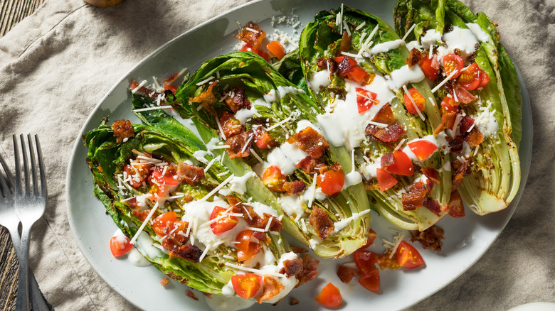 Grilled romaine lettuce with dressing on a plate 