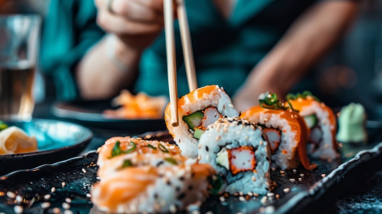 picking up sushi with chopsticks