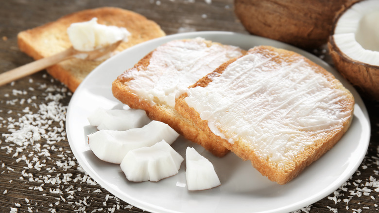 Toast slathered with coconut oil on plate