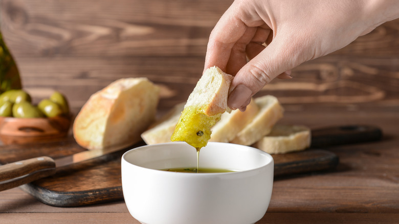 Dipping bread in olive oil 