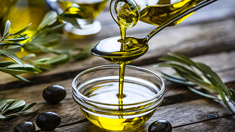 olive oil poured into spoon