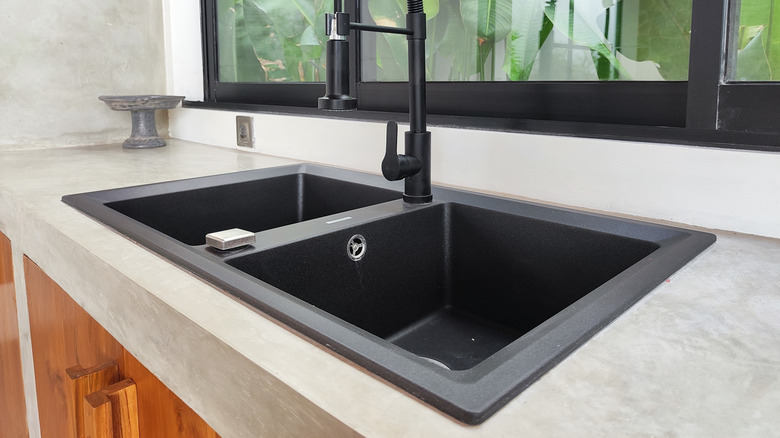 Honed quartz kitchen countertop and a black sink