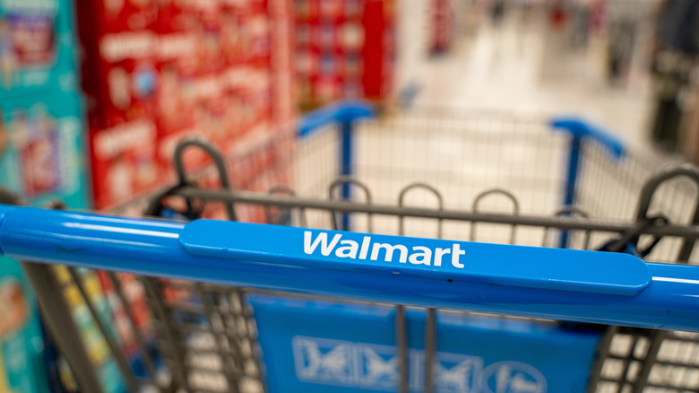 Walmart shopping cart in a store aisle.
