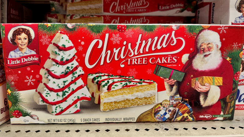 A box of Little Debbie Christmas Tree cakes on a grocery store shelf.