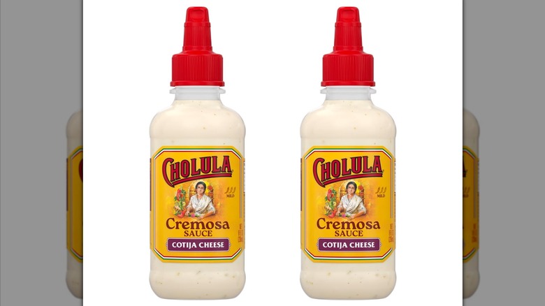 Two bottles of Cholula Cotija Cheese Cremosa Sauce