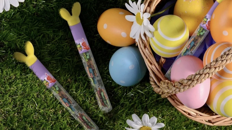 Two Sour Patch Kids Easter containers alongside basket.
