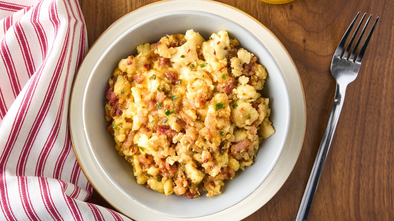 A bowl with Jimmy Dean breakfast next to a fork and napkin.