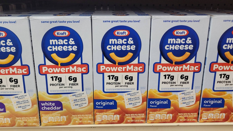 Kraft mac and cheese boxes sit in a row on a shelf
