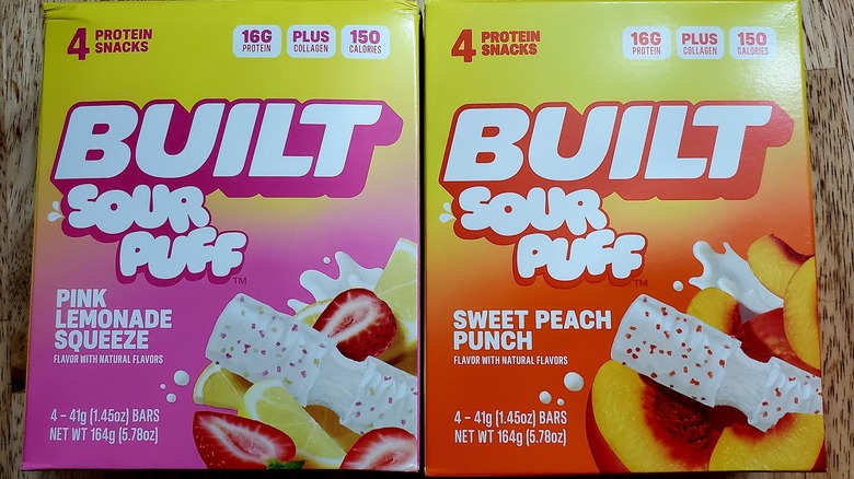 Boxes of BUILT Sour Puff Protein Bars sit on a table