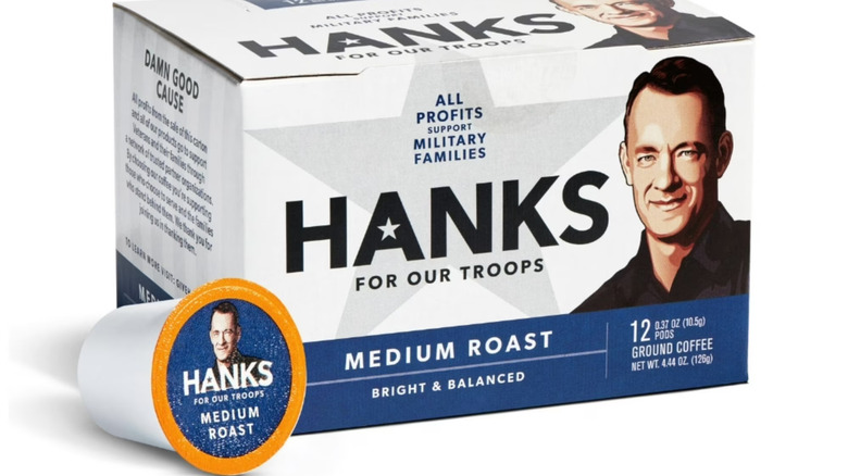 A box of Hanks for Our Troops medium roast coffee with a coffee pod laying adjacent