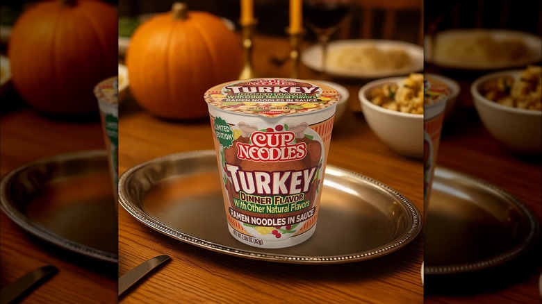 A package of Cup Noodles Turkey Dinner Flavor on a silver tray, placed on a table set for Thanksgiving dinner