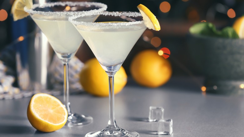 Two lemon drop martinis on gray table