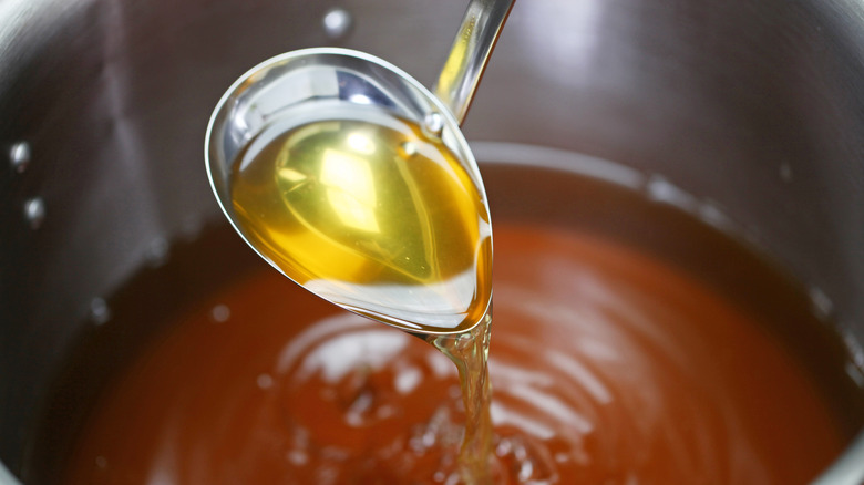 Ladle of chicken stock