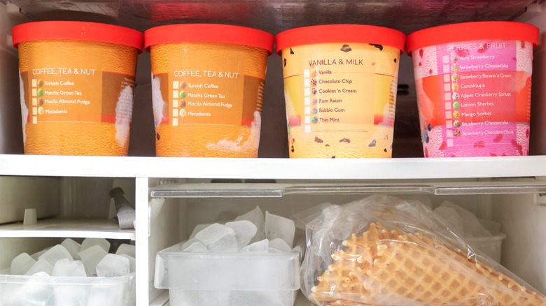 four tubs of ice cream in freezer