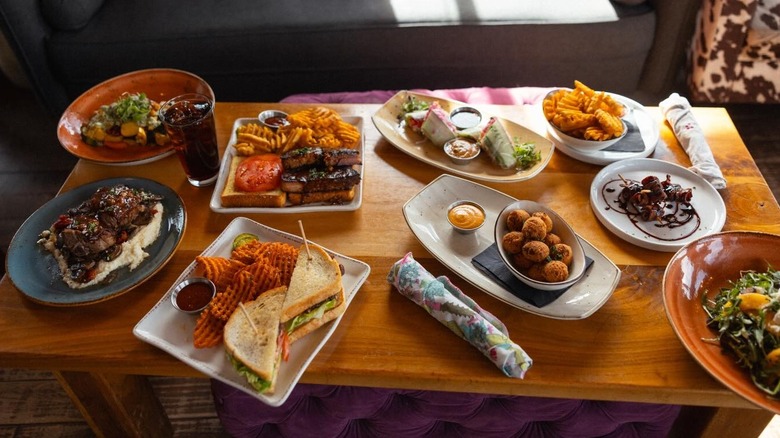 Assortment of menu items from Bird & Jim, including sandwiches, risotto balls, and more