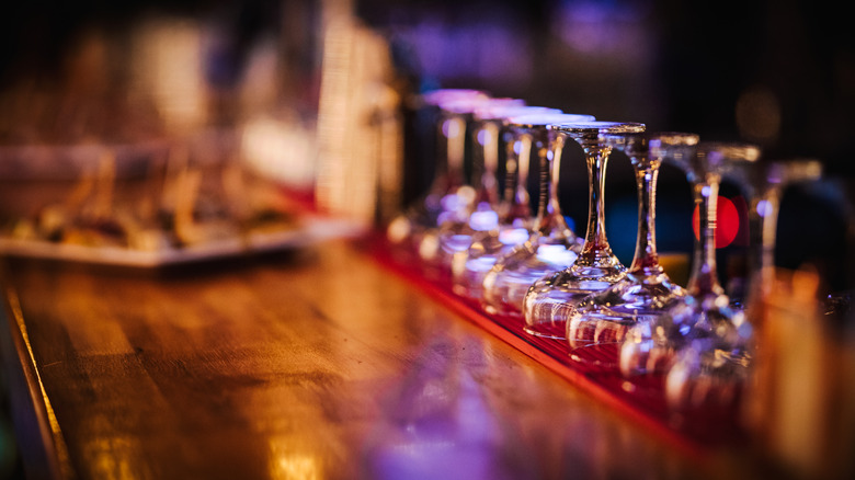 line of glasses stored on bar