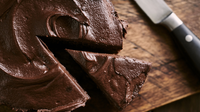 Chocolate cake on wooden cutting board