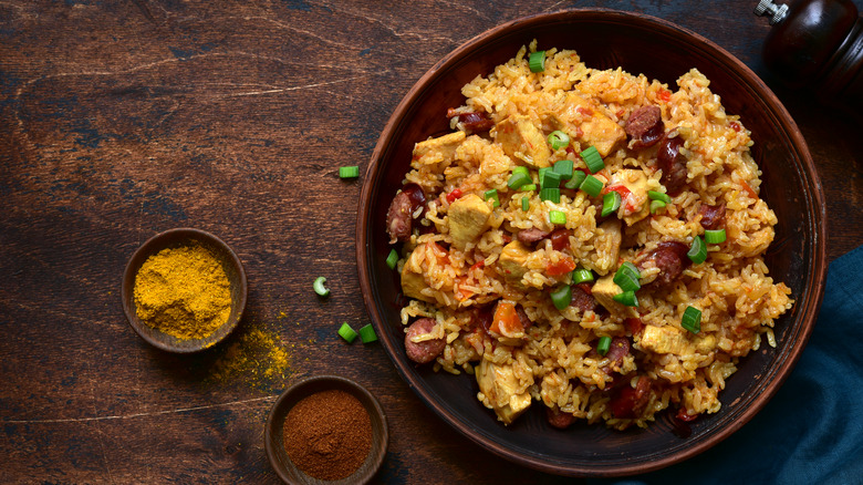 Bowl of jambalaya next to spices