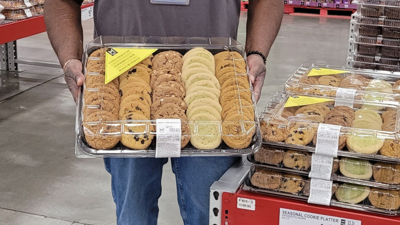A Sam's Club employee holds a tray of seasonal cookies