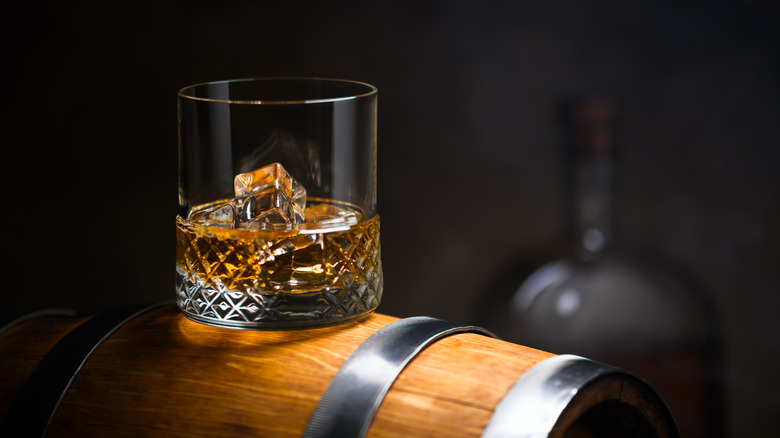 A glass of Scotch on a crate.