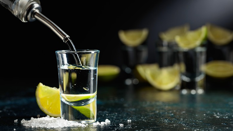 Tequila being poured into a shot glass