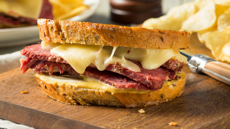 Close up of pastrami meat cheese sandwich on rye bread