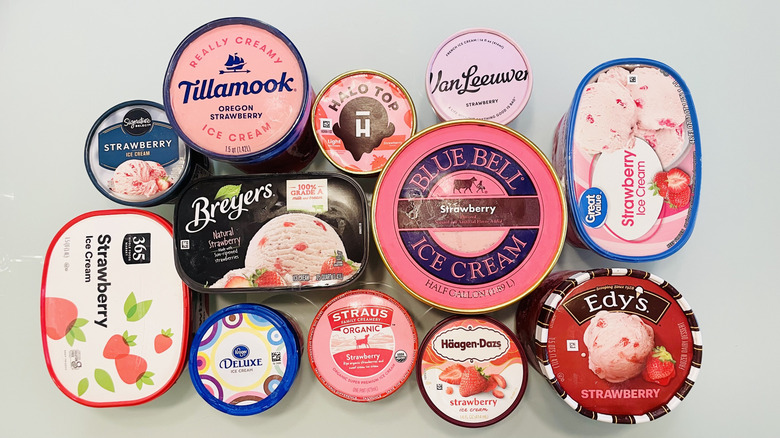 A variety of strawberry ice cream cartons can be viewed from overhead