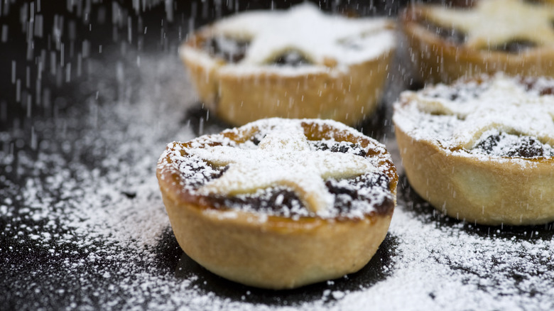 Powdered sugar falling on mince pies