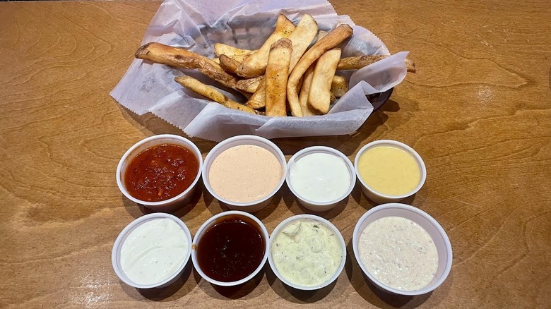 Various Texas Roadhouse dipping sauces and fries.