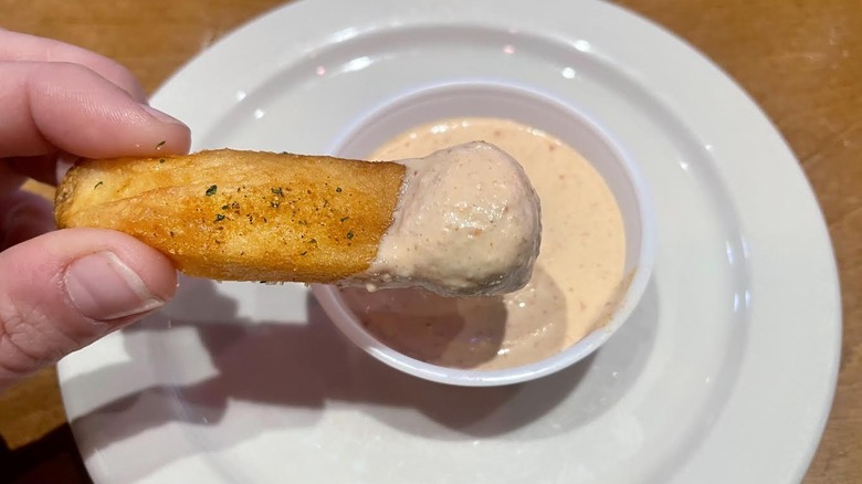 A fry dipped into Texas Roadhouse's Cajun horseradish sauce.