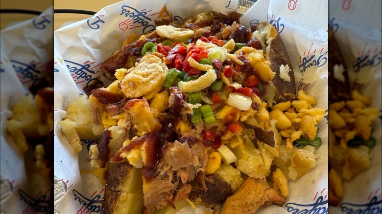 Baked potato topped with meet, mac & cheese, and other toppings in Dodgers paper