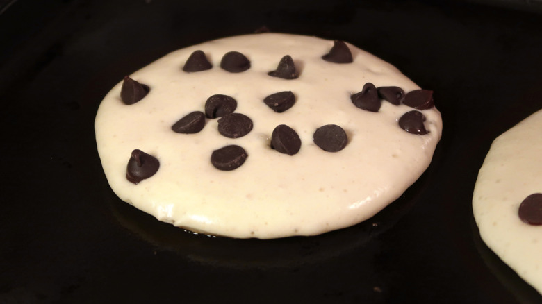 Chocolate chip pancake batter cooking