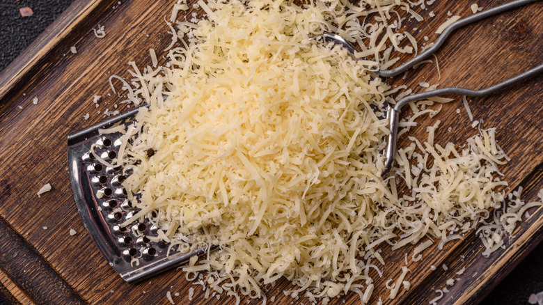 Grated parmesan on a wooden board.