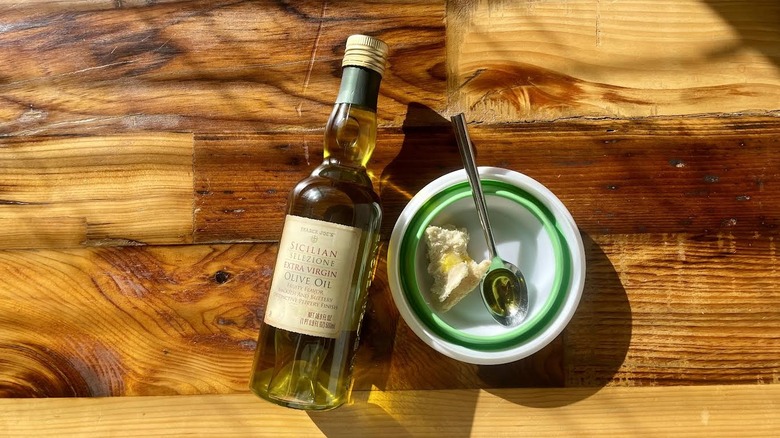 Trader Joe's Sicilian Selezione Extra Virgin Olive Oil bottle next to a plate