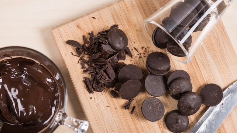 Disks of couverture chocolate being chopped and melted