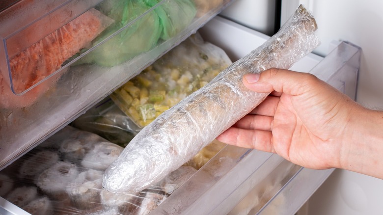 Person taking frozen fish out of freezer