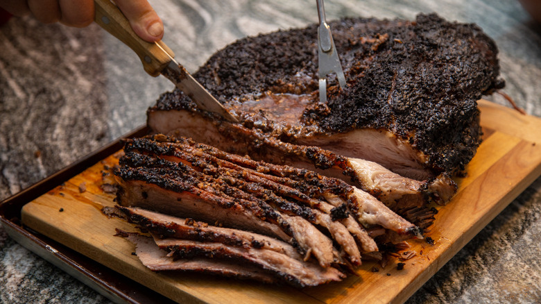 Beef brisket being sliced after smoking