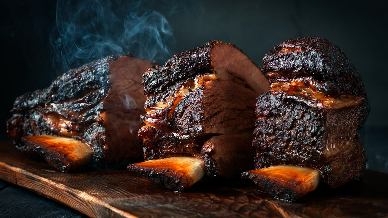 Whole smoked brisket on a wooden cutting board