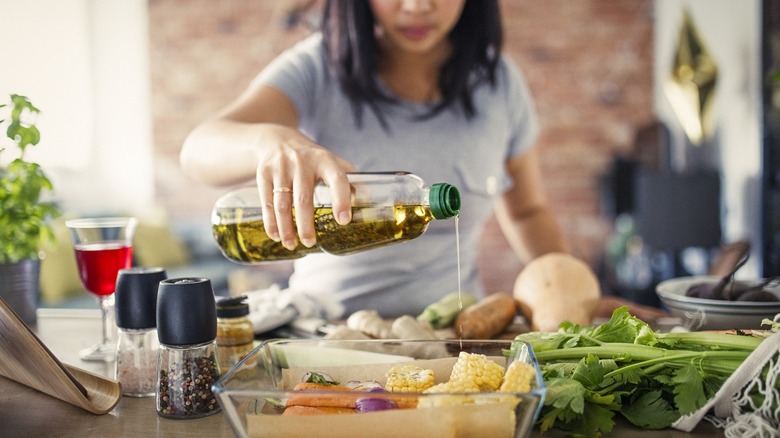 Woman cooking with vegetable oil