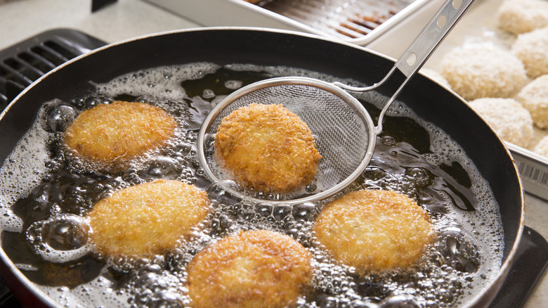 Croquettes cooking in deep fryer