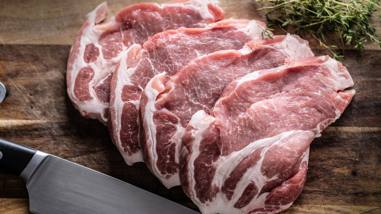 Pork steaks on a wooden cutting board