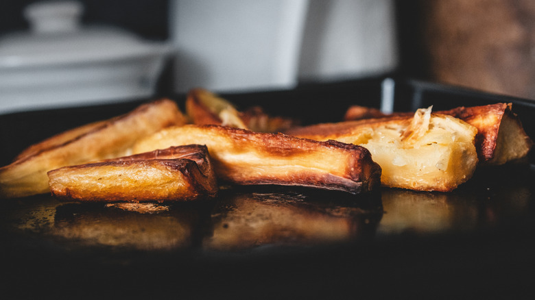 Caramelized parsnips sit on a baking sheet