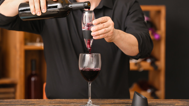 Pouring wine through an aerator into a glass
