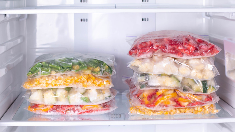 Frozen vegetables stacked in freezer