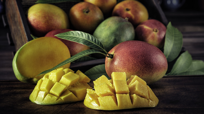 pile of cut and whole mangos