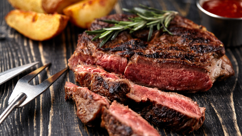 Steak cut up topped with herbs